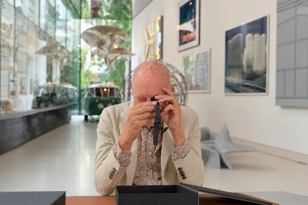 Norman Foster inspecting the Lebond Norman Foster watch with a loupe