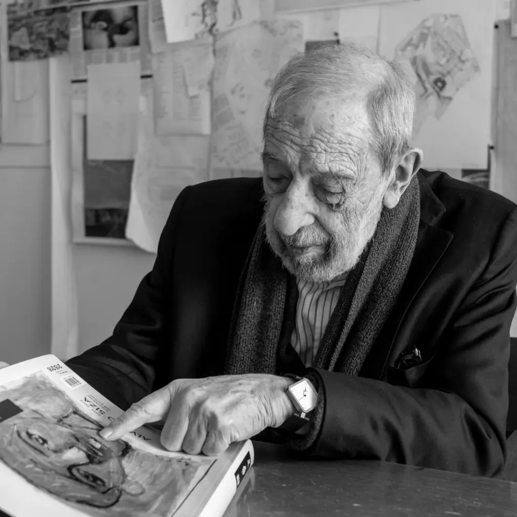Álvaro Siza with a monograph of his work, wearing the Lebond Siza, in his Porto studio